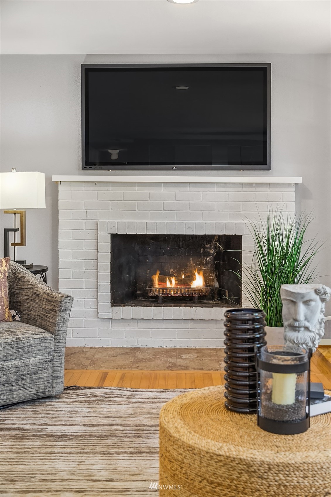 3310 199th Place Southeast Bothell, WA 98012 - Photo 5 of 30 a living room with furniture a fireplace and a flat screen tv