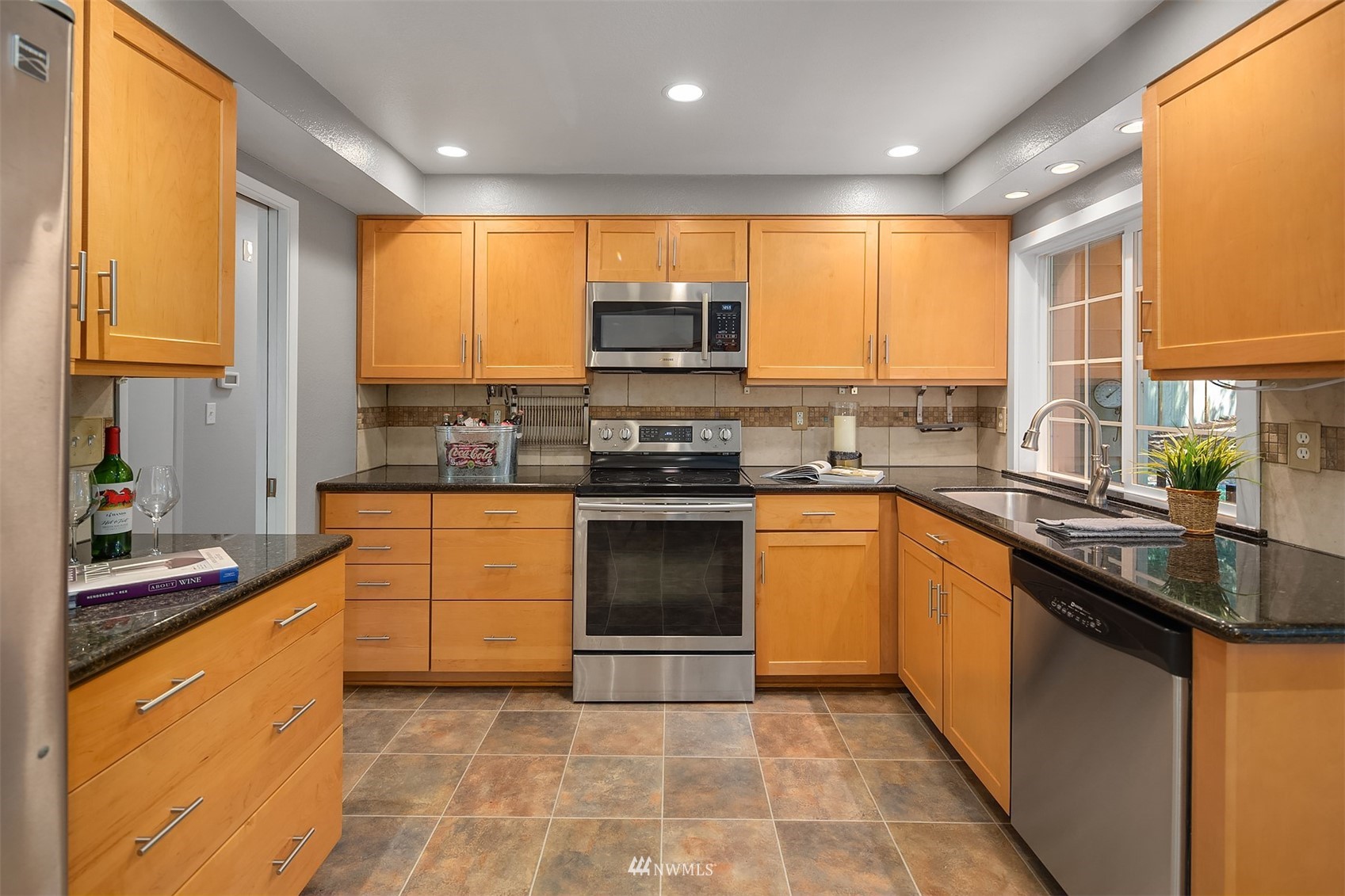 3310 199th Place Southeast Bothell, WA 98012 - Photo 10 of 30 a kitchen with stainless steel appliances granite countertop a stove a sink and a microwave