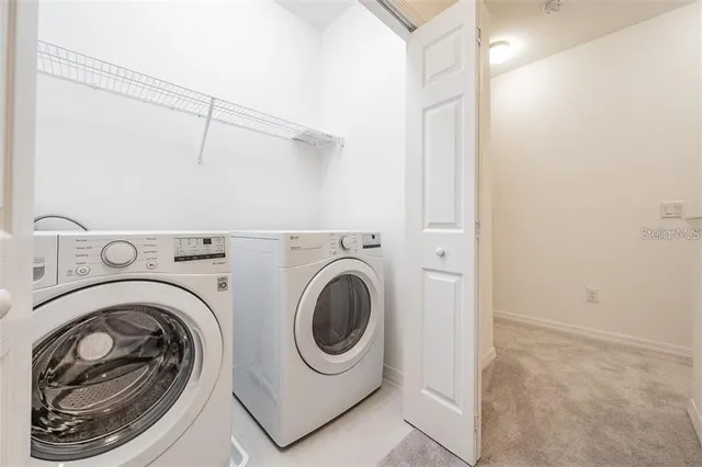 an empty room with windows and a ceiling fan