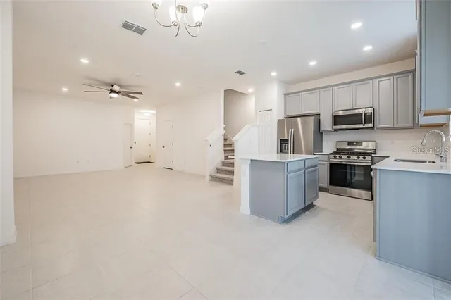 a large kitchen with cabinets and stainless steel appliances