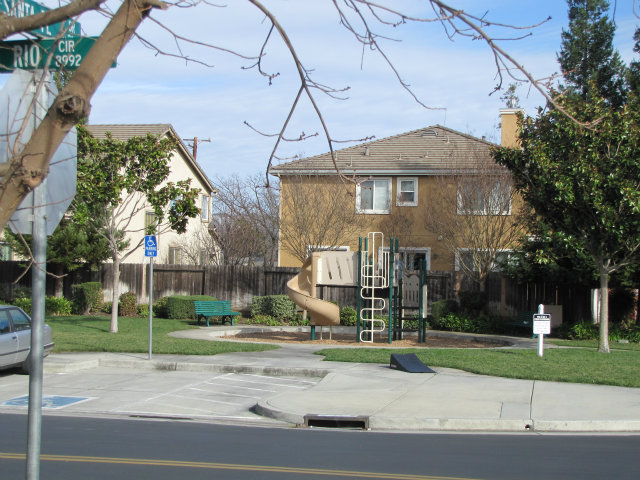8992 Del Rio Circle Gilroy, CA 95020 - Photo 2 of 19 a view of a white house with a clock tower in middle of a yard