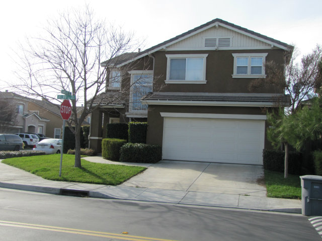 8992 Del Rio Circle Gilroy, CA 95020 - Photo 3 of 19 a front view of a house with a garden