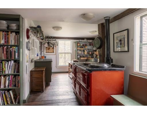 153 Argilla Road Ipswich, MA 01938 - Photo 5 of 27 a kitchen with stainless steel appliances granite countertop a stove and a bookshelf
