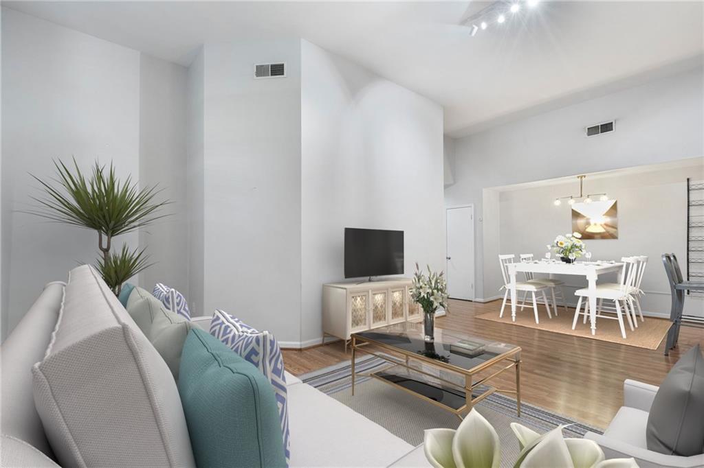 1031 State Street Northwest, Unit 106 Atlanta, GA 30318 - Photo 11 of 23 a living room with furniture and a flat screen tv