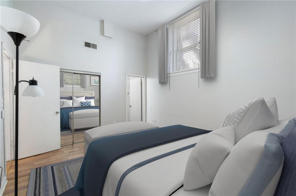 1031 State Street Northwest, Unit 106 Atlanta, GA 30318 - Photo 13 of 23 a bedroom with a bed and a view of bathroom