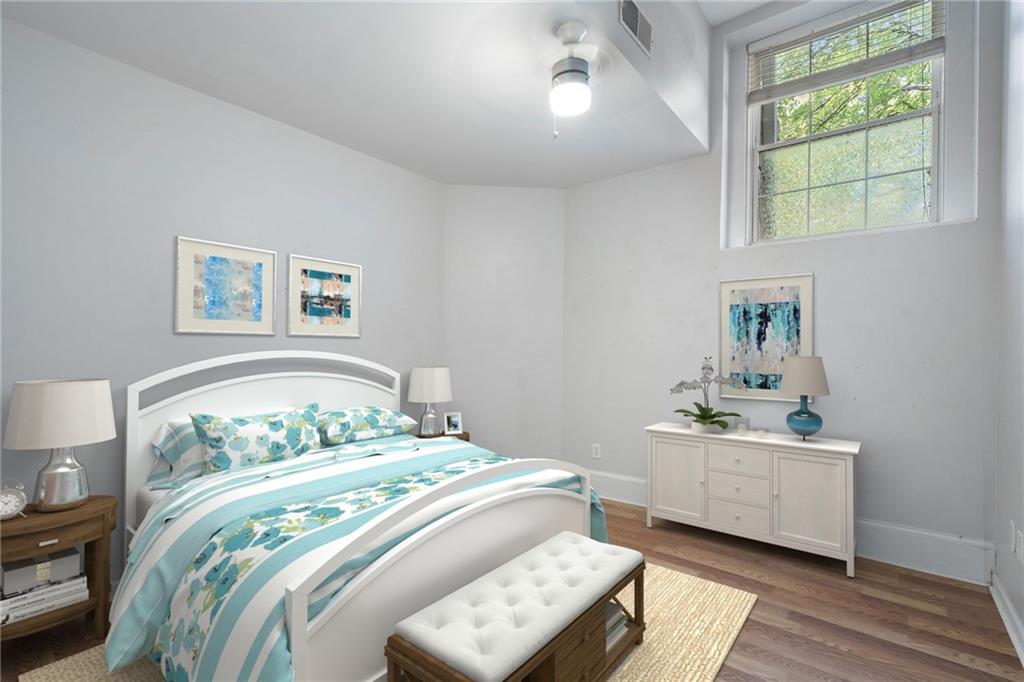 1031 State Street Northwest, Unit 106 Atlanta, GA 30318 - Photo 16 of 23 a bedroom with a bed and a window