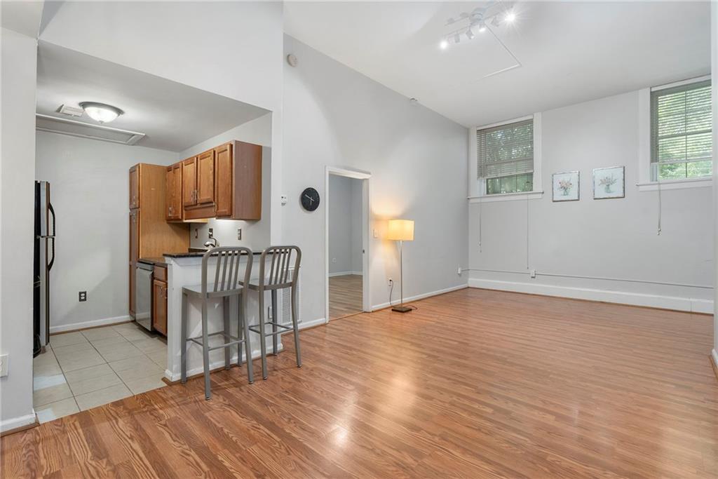 1031 State Street Northwest, Unit 106 Atlanta, GA 30318 - Photo 6 of 23 a view of kitchen with furniture and wooden floor