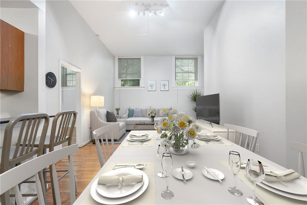 1031 State Street Northwest, Unit 106 Atlanta, GA 30318 - Photo 9 of 23 a dining room with furniture and wooden floor