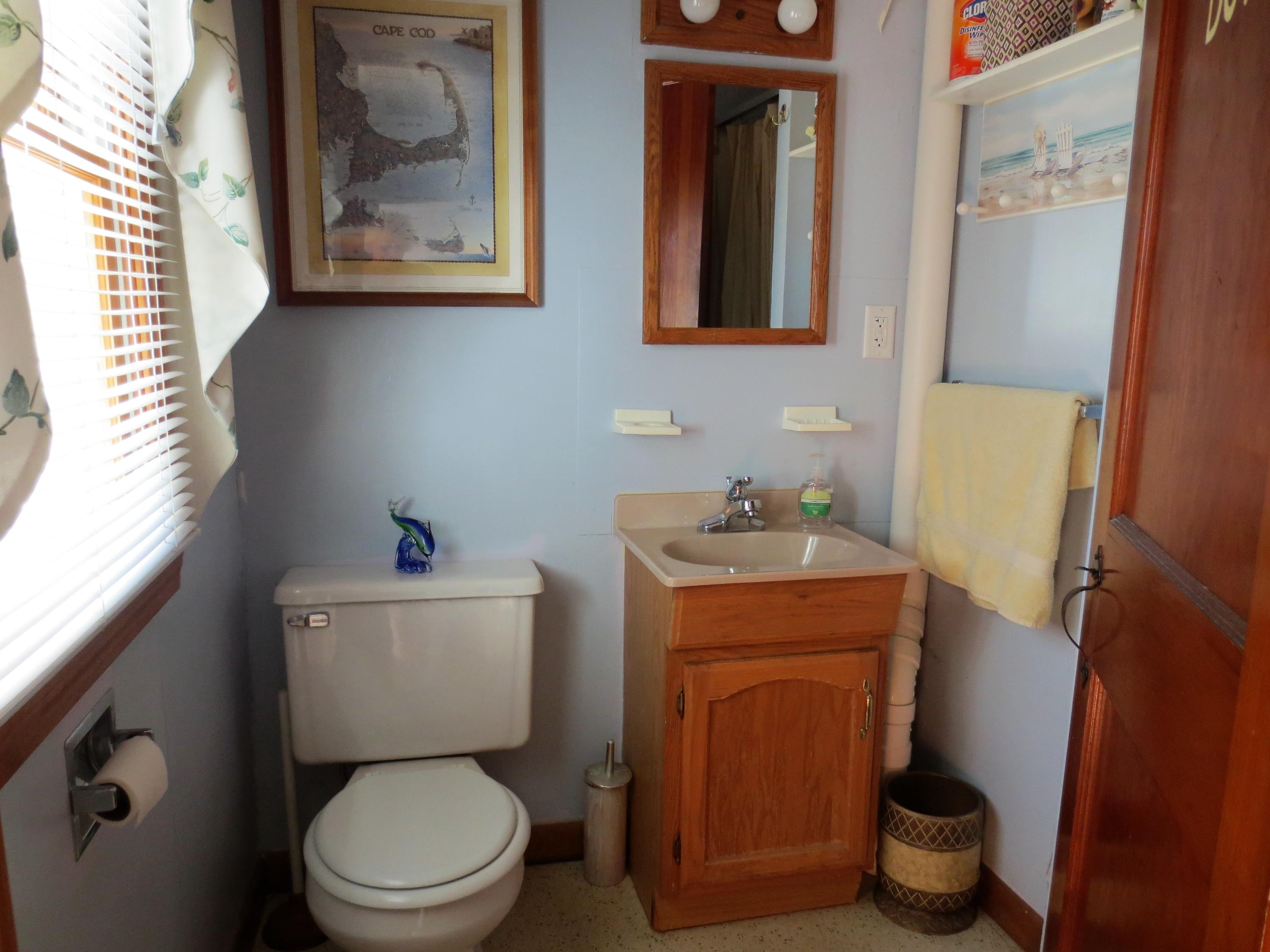 291 Lower County Road, Unit E Dennis Port, MA 02639 - Photo 14 of 31 a bathroom with a toilet and a sink