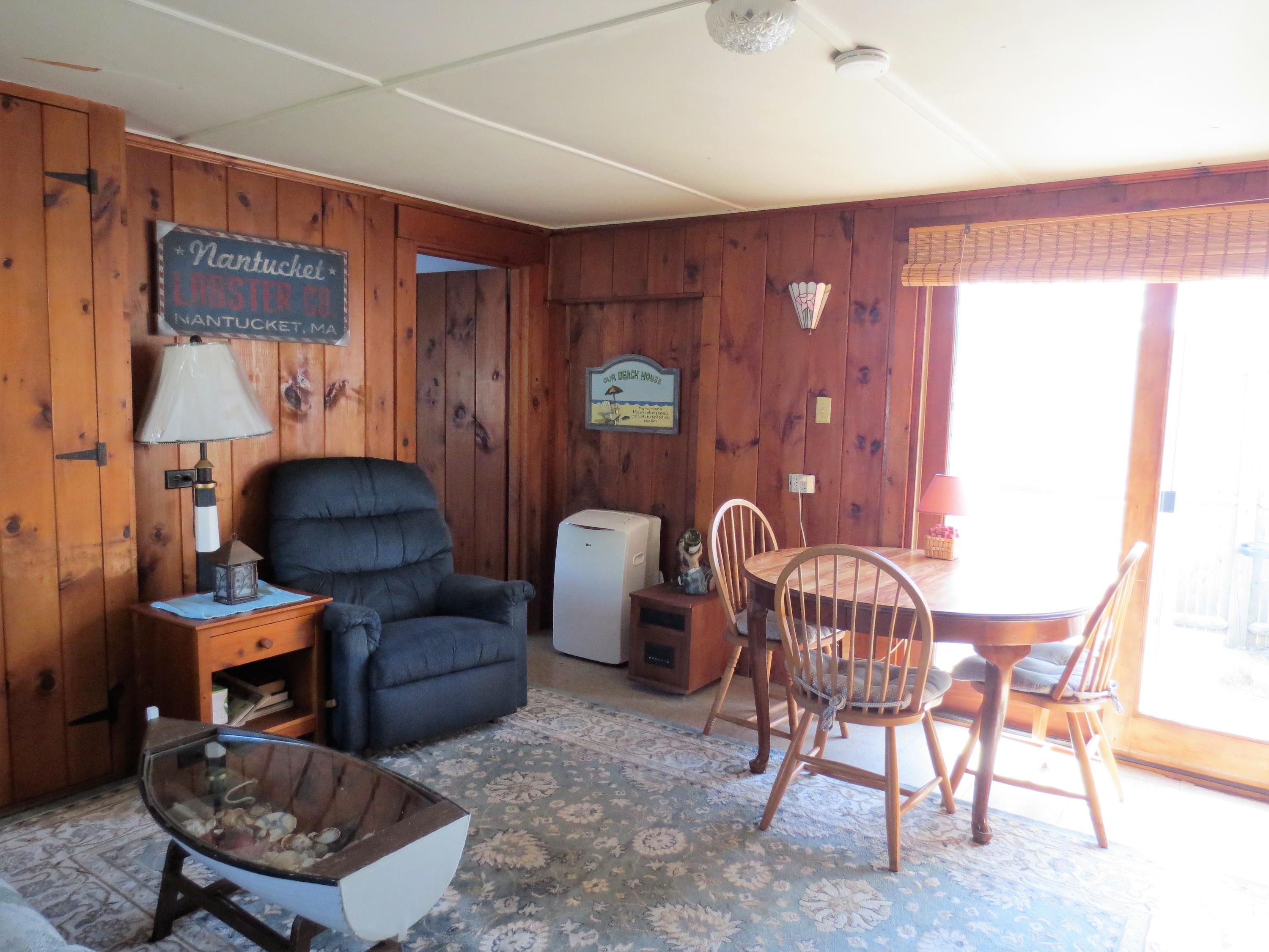 291 Lower County Road, Unit E Dennis Port, MA 02639 - Photo 16 of 31 a living room with furniture a rug and a window