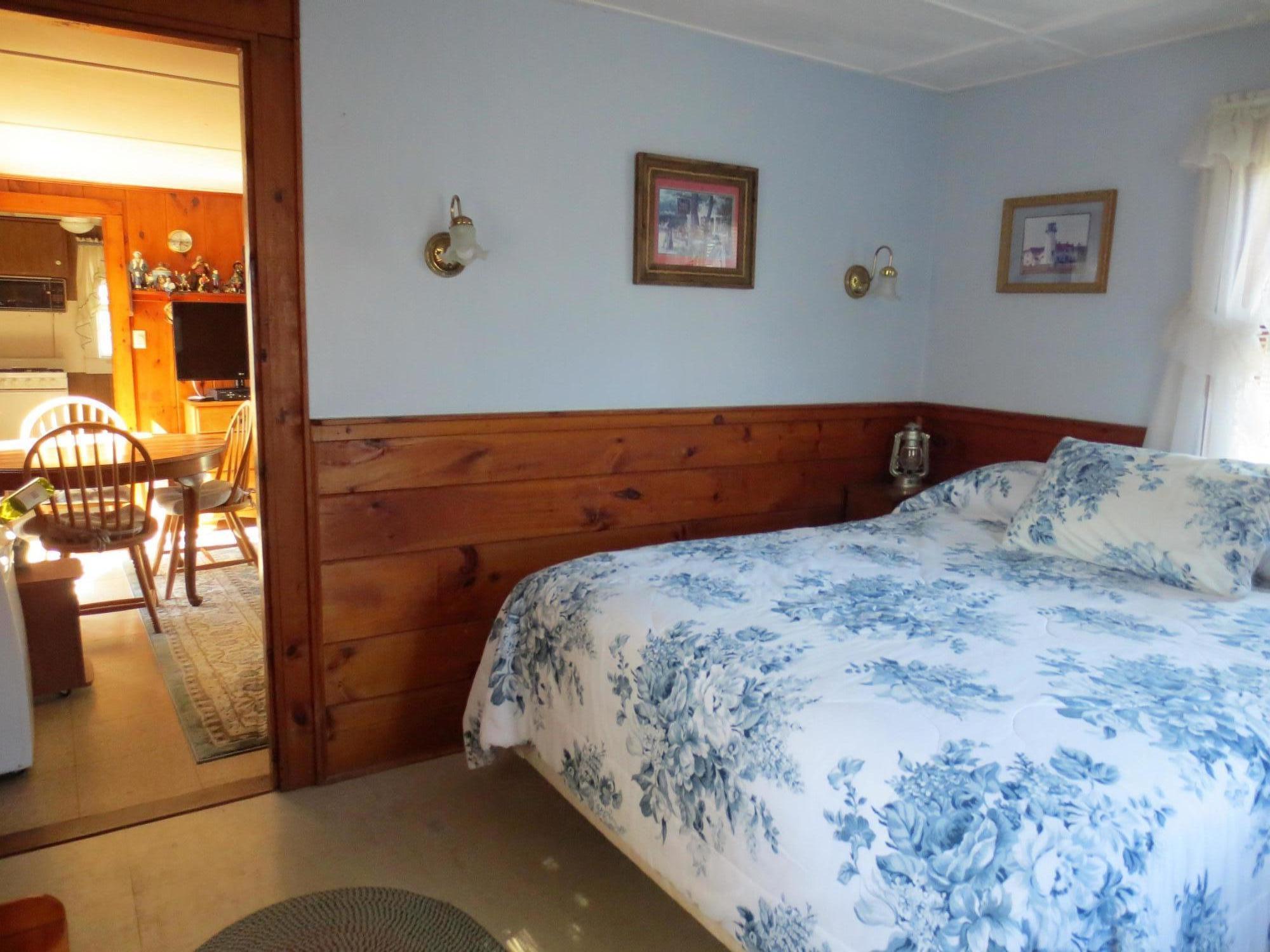 291 Lower County Road, Unit E Dennis Port, MA 02639 - Photo 20 of 31 a bed sitting in a bedroom next to a window