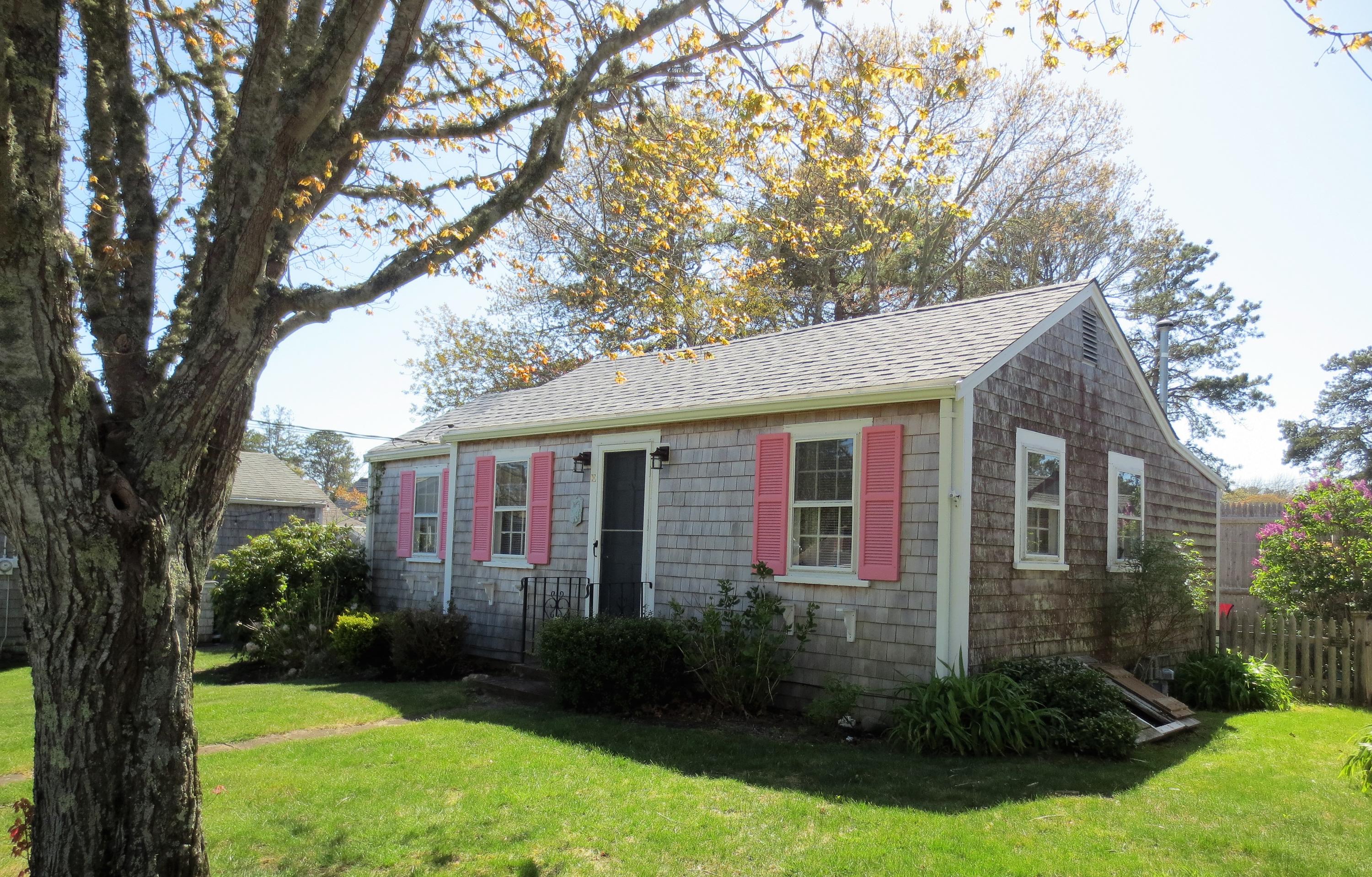 291 Lower County Road, Unit E Dennis Port, MA 02639 - Photo 2 of 31 a front view of a house with garden