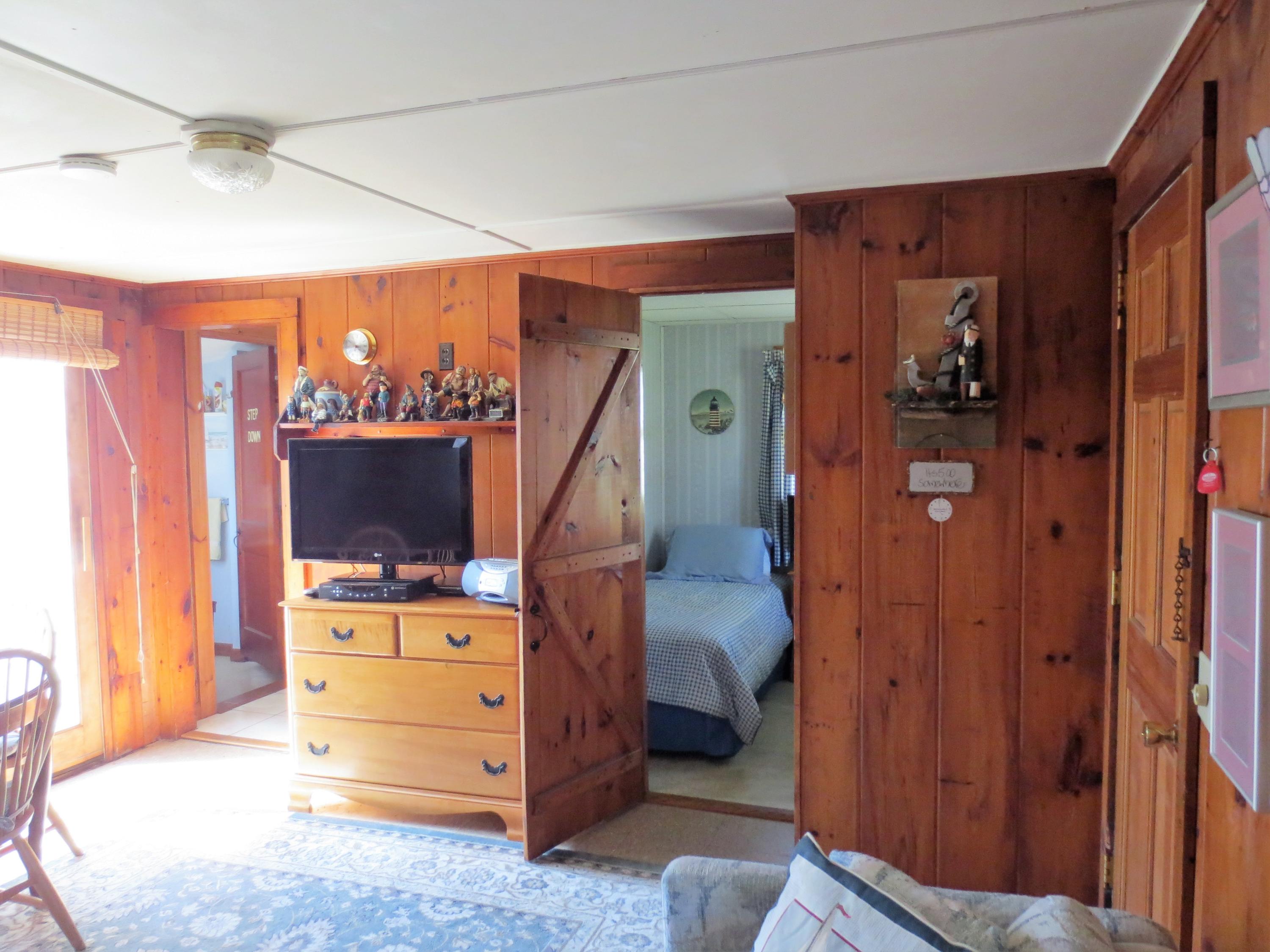 291 Lower County Road, Unit E Dennis Port, MA 02639 - Photo 21 of 31 a view of a livingroom with furniture and a flat screen tv