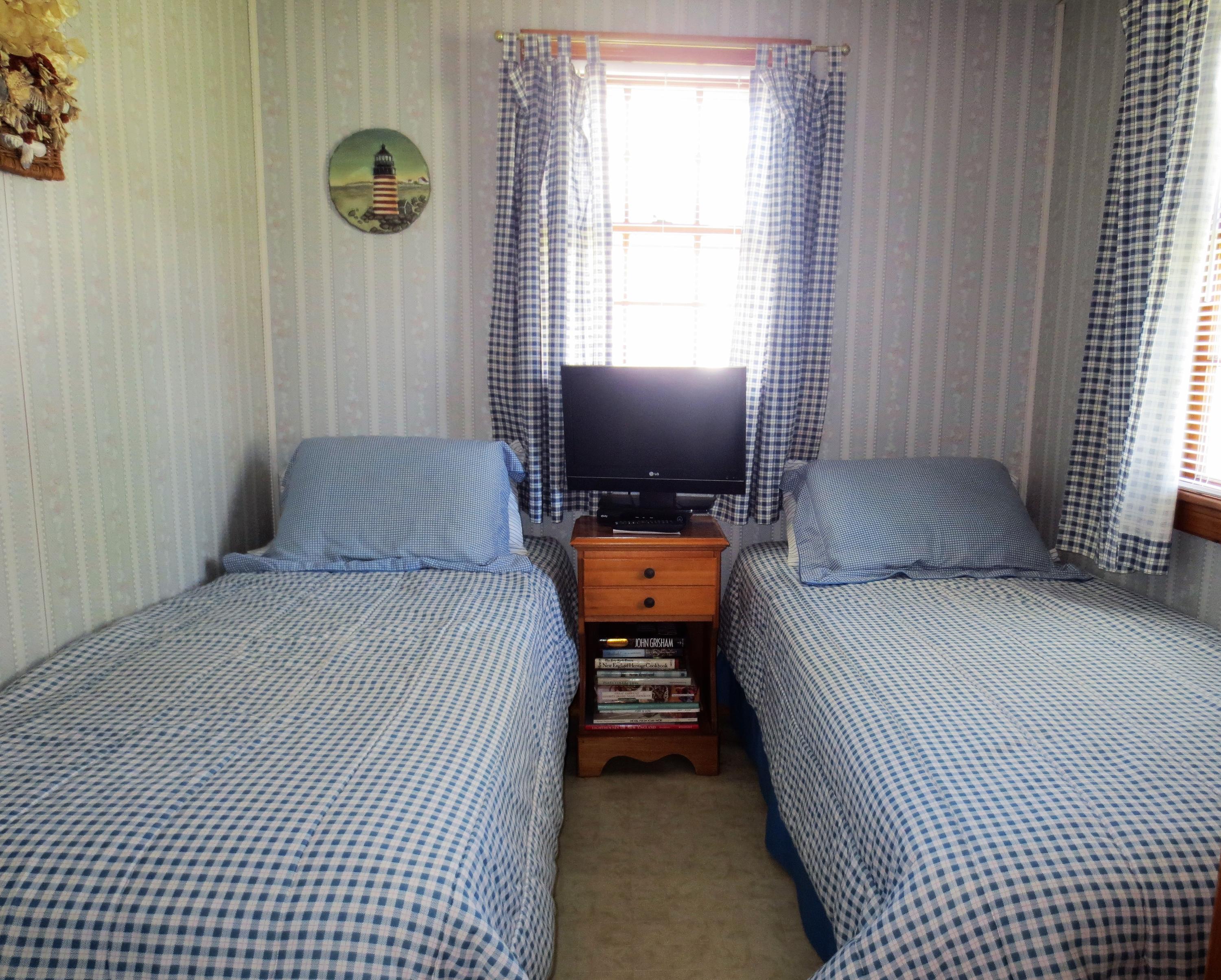 291 Lower County Road, Unit E Dennis Port, MA 02639 - Photo 22 of 31 a bedroom with a bed and a window