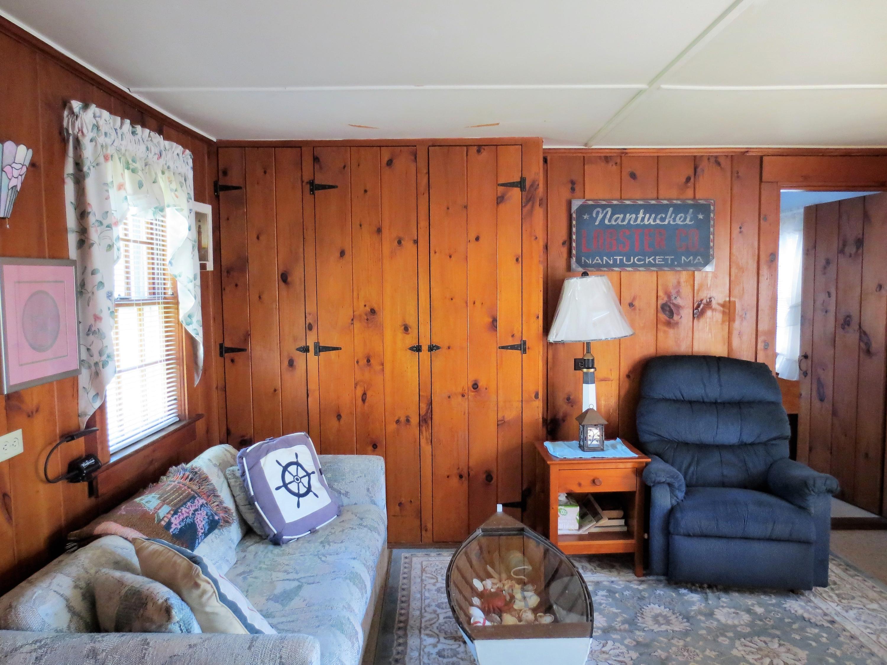 291 Lower County Road, Unit E Dennis Port, MA 02639 - Photo 24 of 31 a living room with furniture and a window