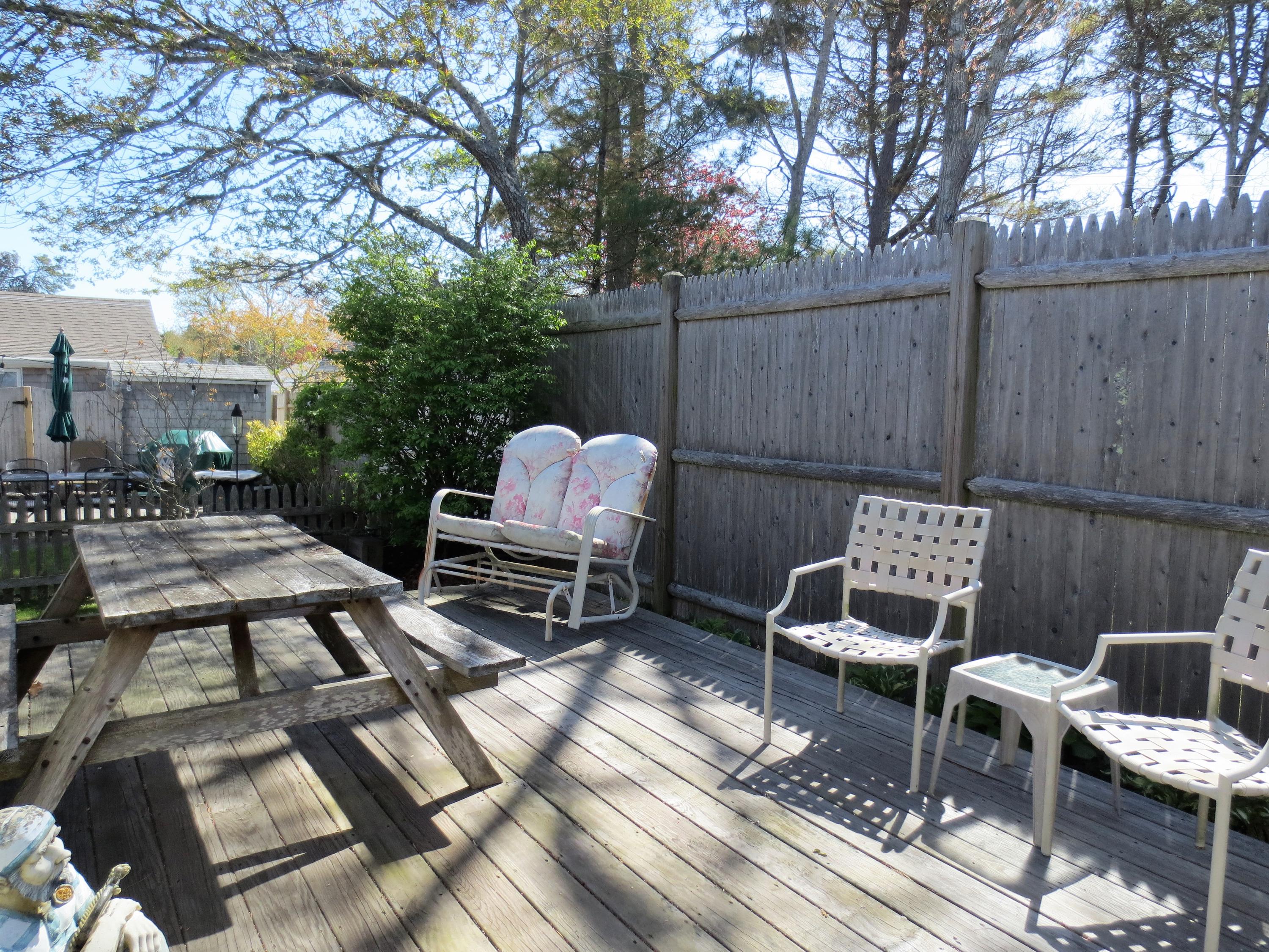 291 Lower County Road, Unit E Dennis Port, MA 02639 - Photo 4 of 31 a backyard of a house with outdoor seating