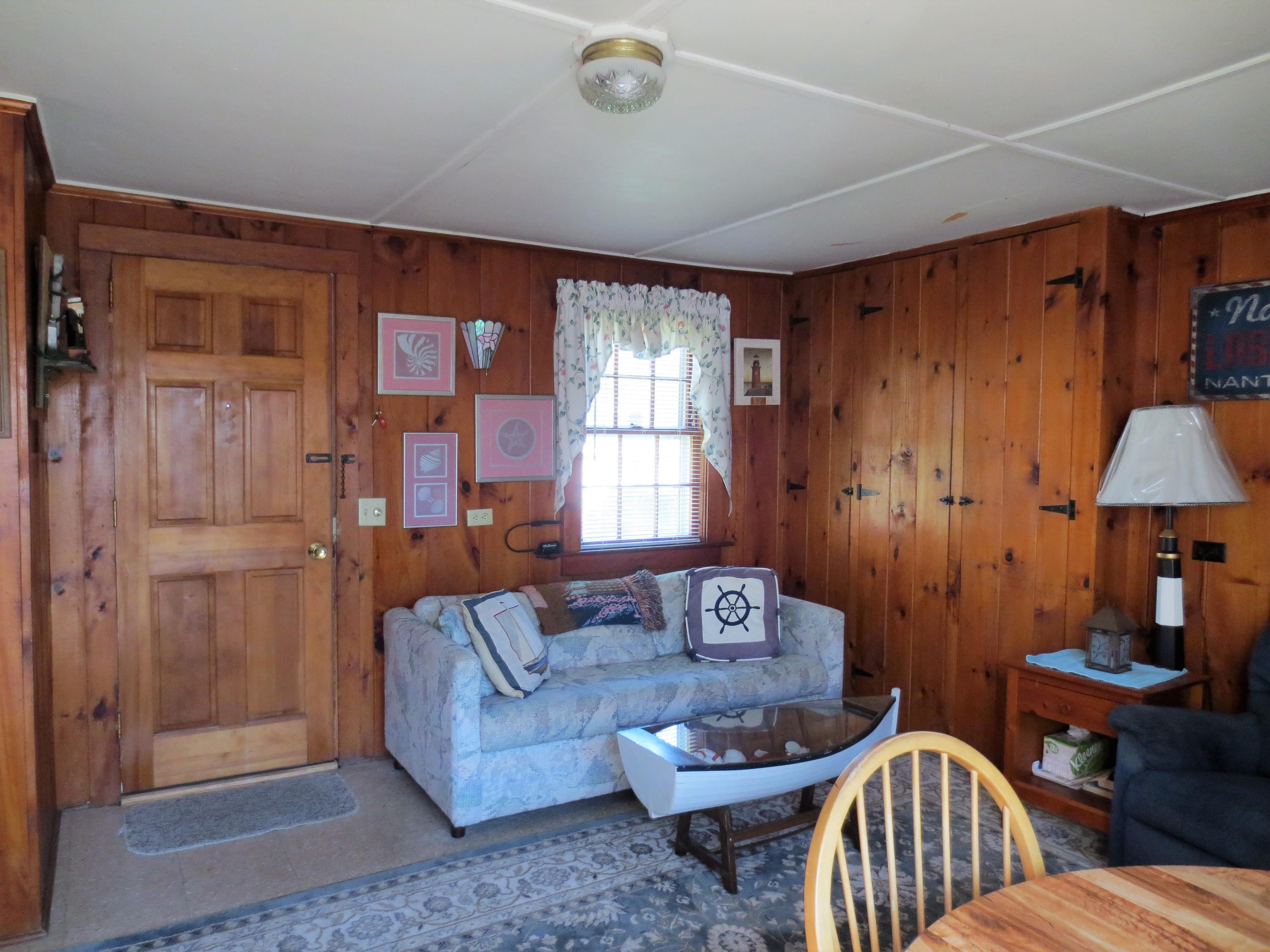 291 Lower County Road, Unit E Dennis Port, MA 02639 - Photo 8 of 31 a living room with furniture and a window
