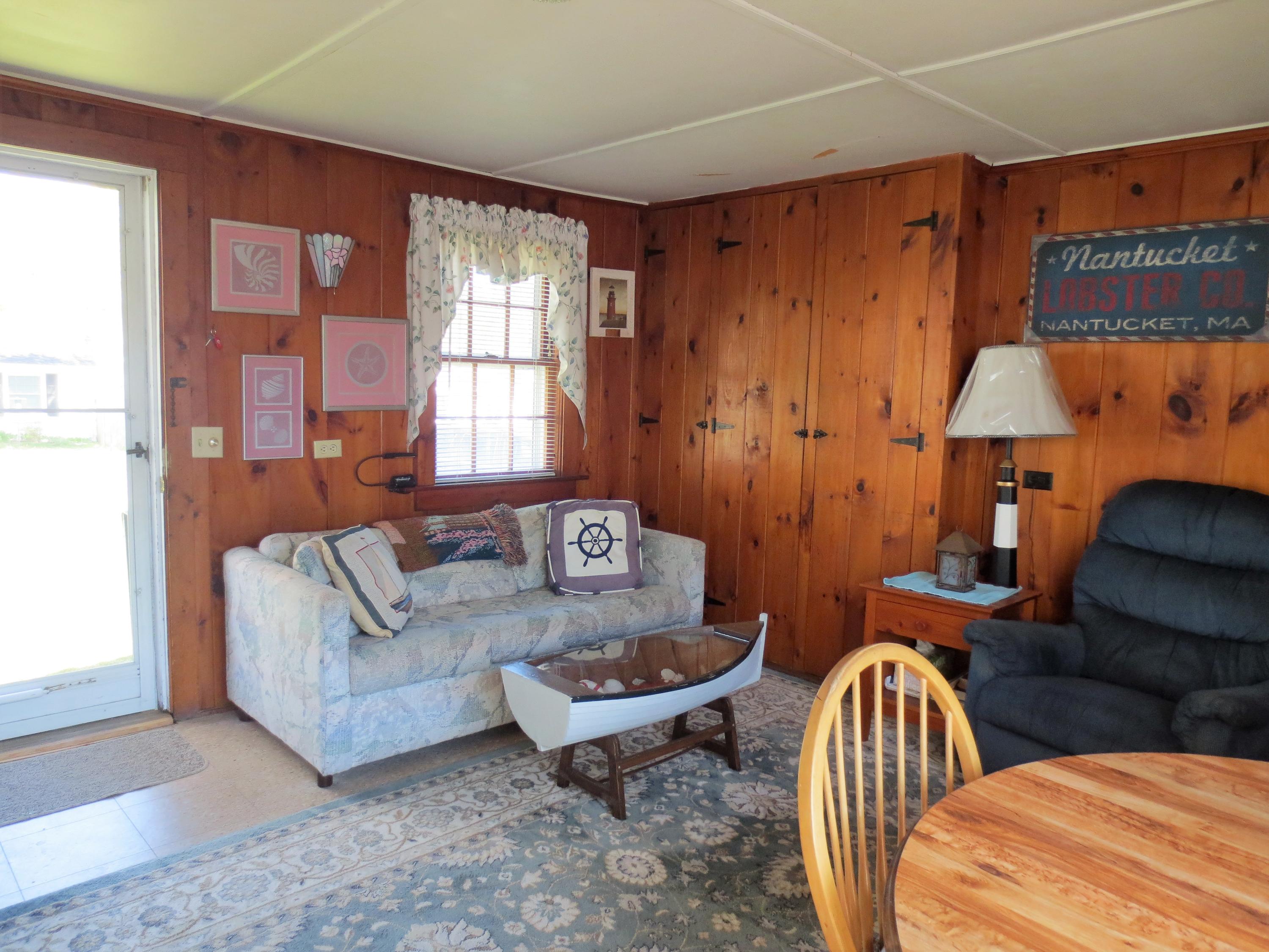 291 Lower County Road, Unit E Dennis Port, MA 02639 - Photo 9 of 31 a living room with furniture and a window