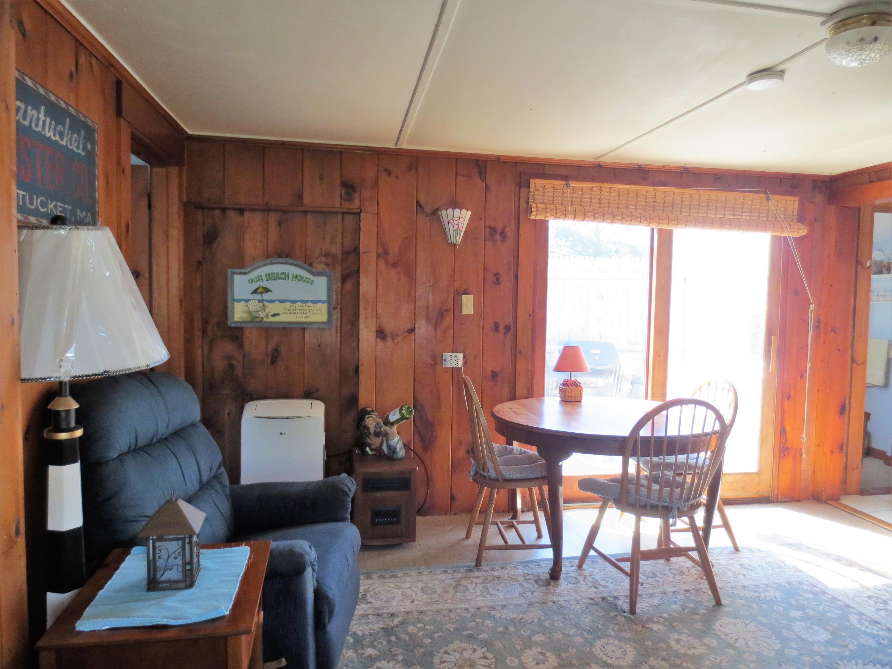 291 Lower County Road, Unit E Dennis Port, MA 02639 - Photo 10 of 31 a view of a livingroom with furniture and a window