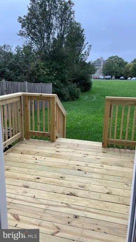 a view of a house with a wooden deck