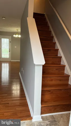 a view of entryway and hall with wooden floor