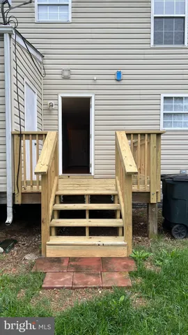 a view of a house with a yard and stairs