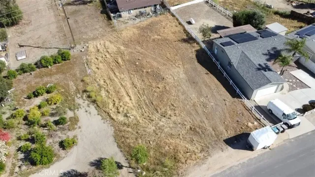 an aerial view of a house with a yard