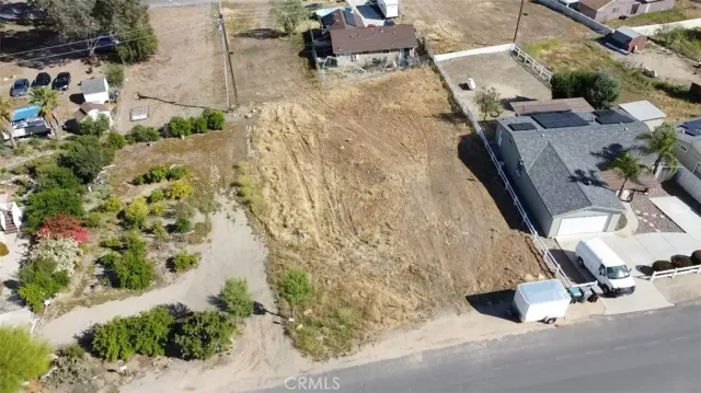 an aerial view of a house with a yard and sitting space