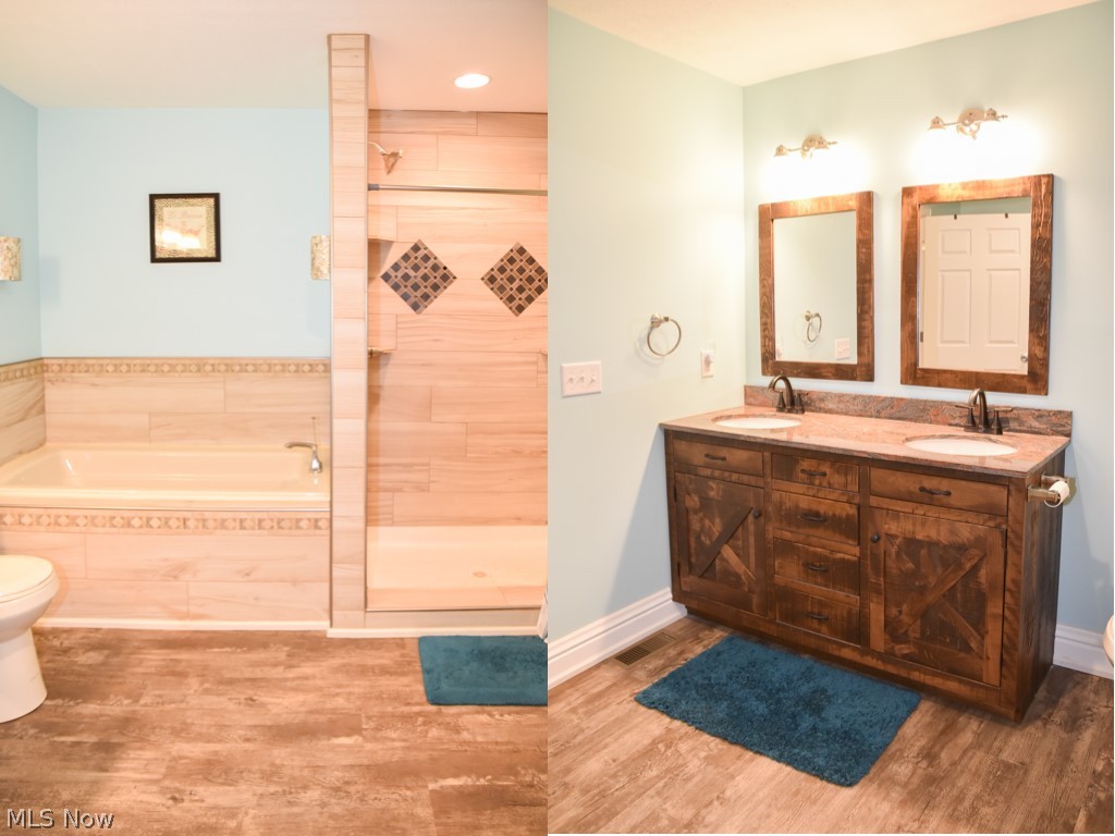 9410 Leroy Road Seville, OH 44273 - Photo 15 of 25 Private master bath with dual sinks, a soaking tub and tiled shower surround.
