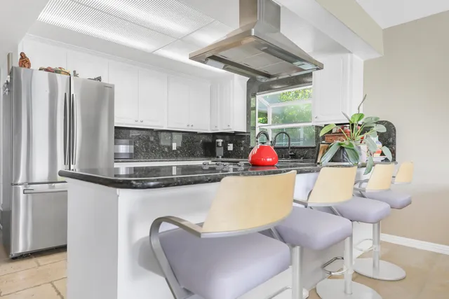 a view of kitchen with furniture and a potted plant