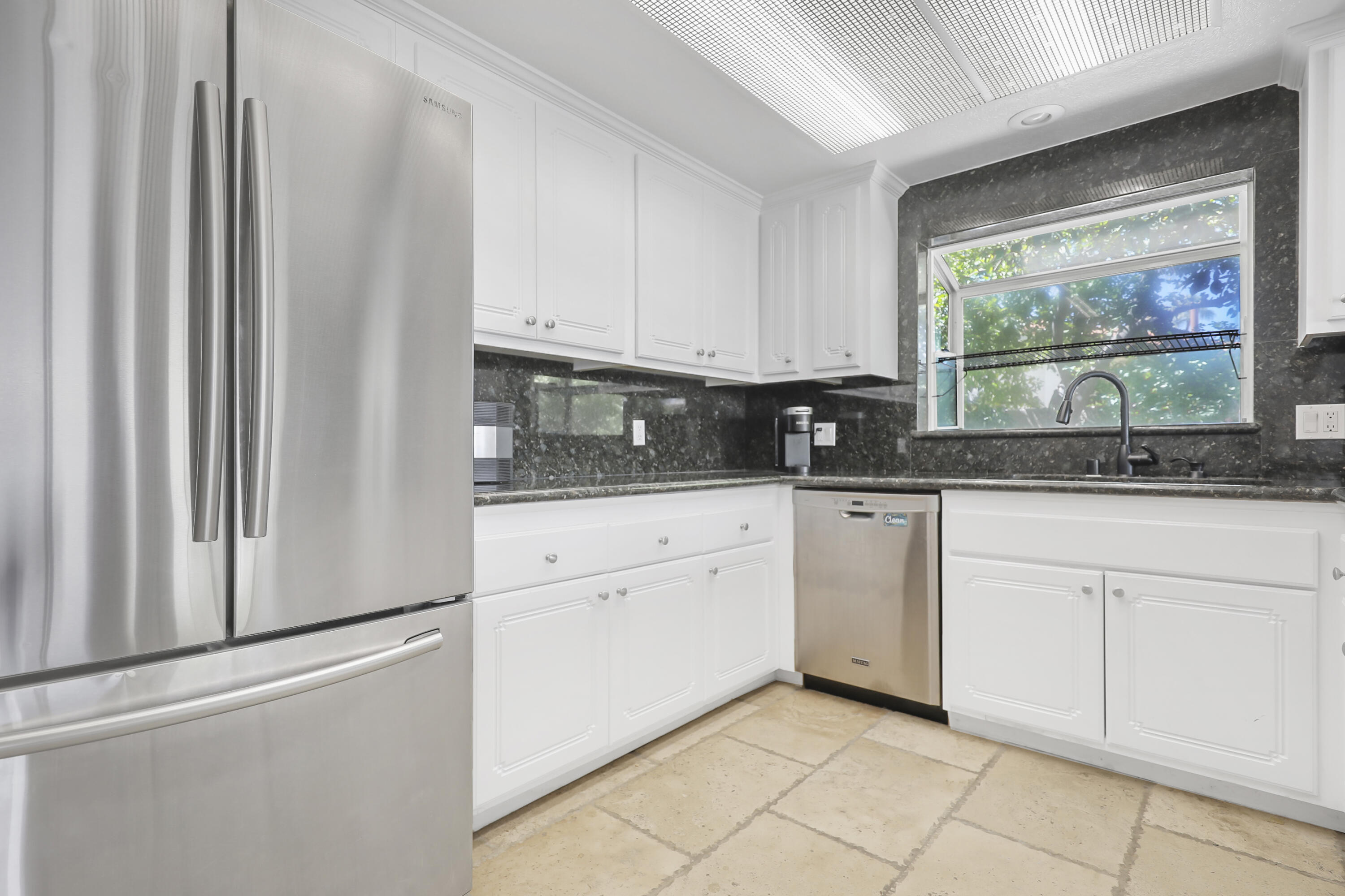 78950 Starlight Lane Bermuda Dunes, CA 92203 - Photo 18 of 40 a kitchen with stainless steel appliances granite countertop white cabinets and window