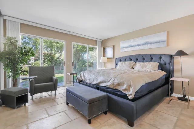 a bedroom with a bed and large window