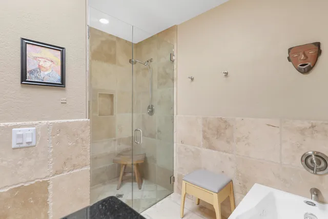 a bathroom with a shower and a sink