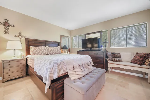 a spacious bedroom with a bed and a couch