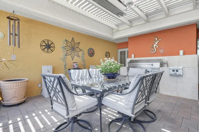 a view of a dining room with furniture and a chandelier