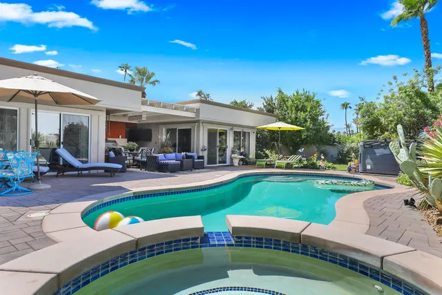 a view of a house with swimming pool and porch