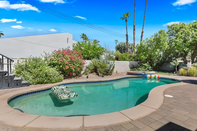 a view of a swimming pool with a outdoor seating