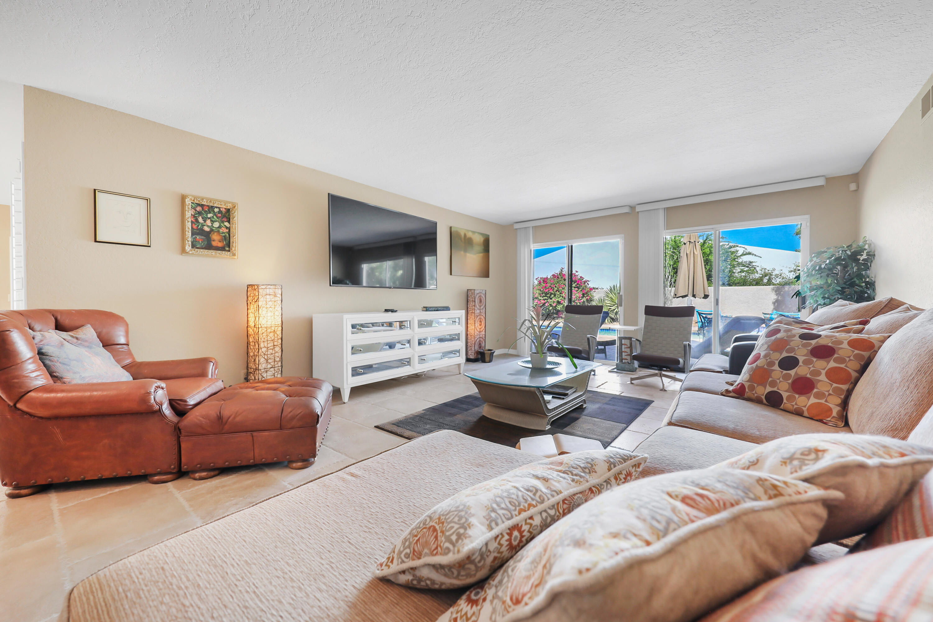 78950 Starlight Lane Bermuda Dunes, CA 92203 - Photo 9 of 40 a living room with furniture a large window and a flat screen tv
