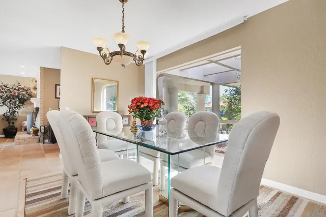 a view of a dining room with furniture and a chandelier