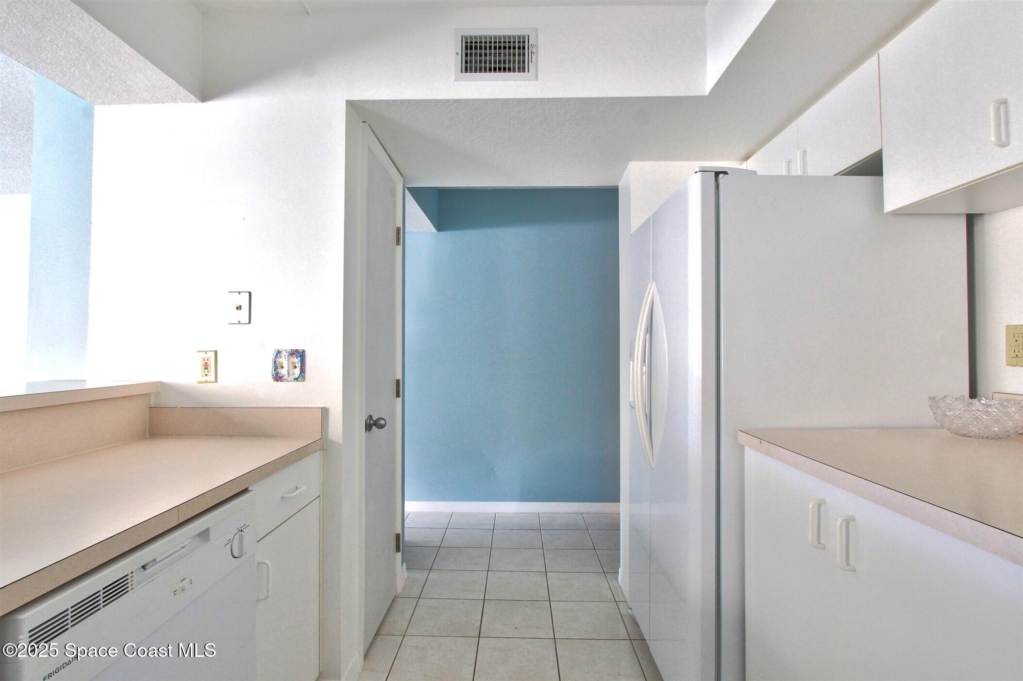 1420 Huntington Lane, Unit 2101 Rockledge, FL 32955 - Photo 11 of 38 a kitchen with a sink and a refrigerator
