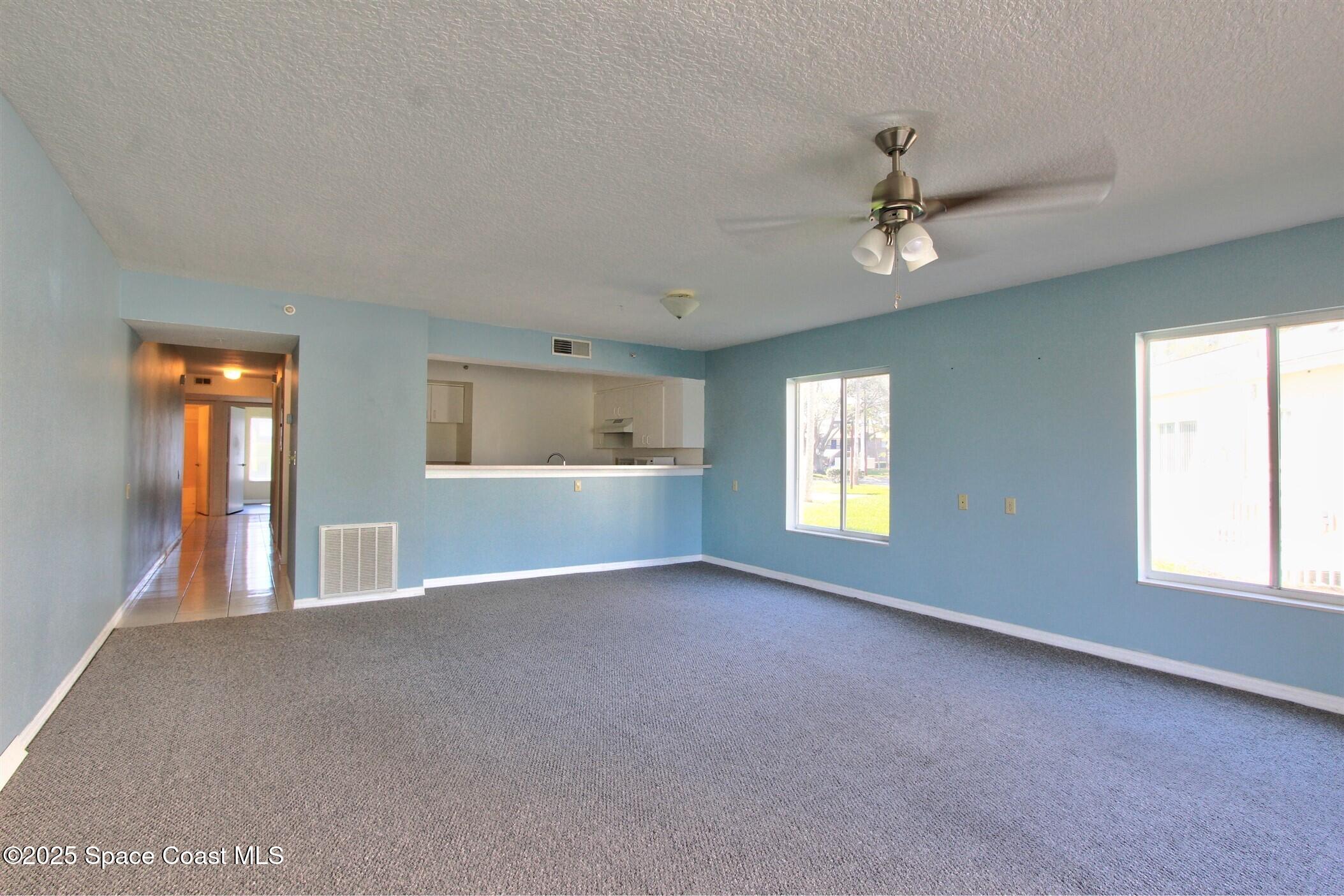 1420 Huntington Lane, Unit 2101 Rockledge, FL 32955 - Photo 12 of 38 a view of empty room with windows
