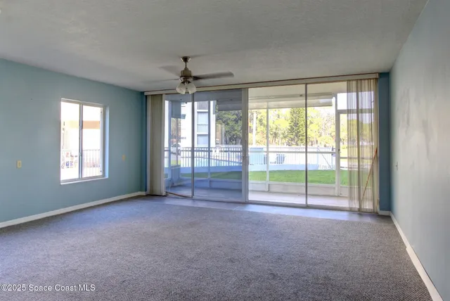 a view of livingroom with a ceiling fan and window