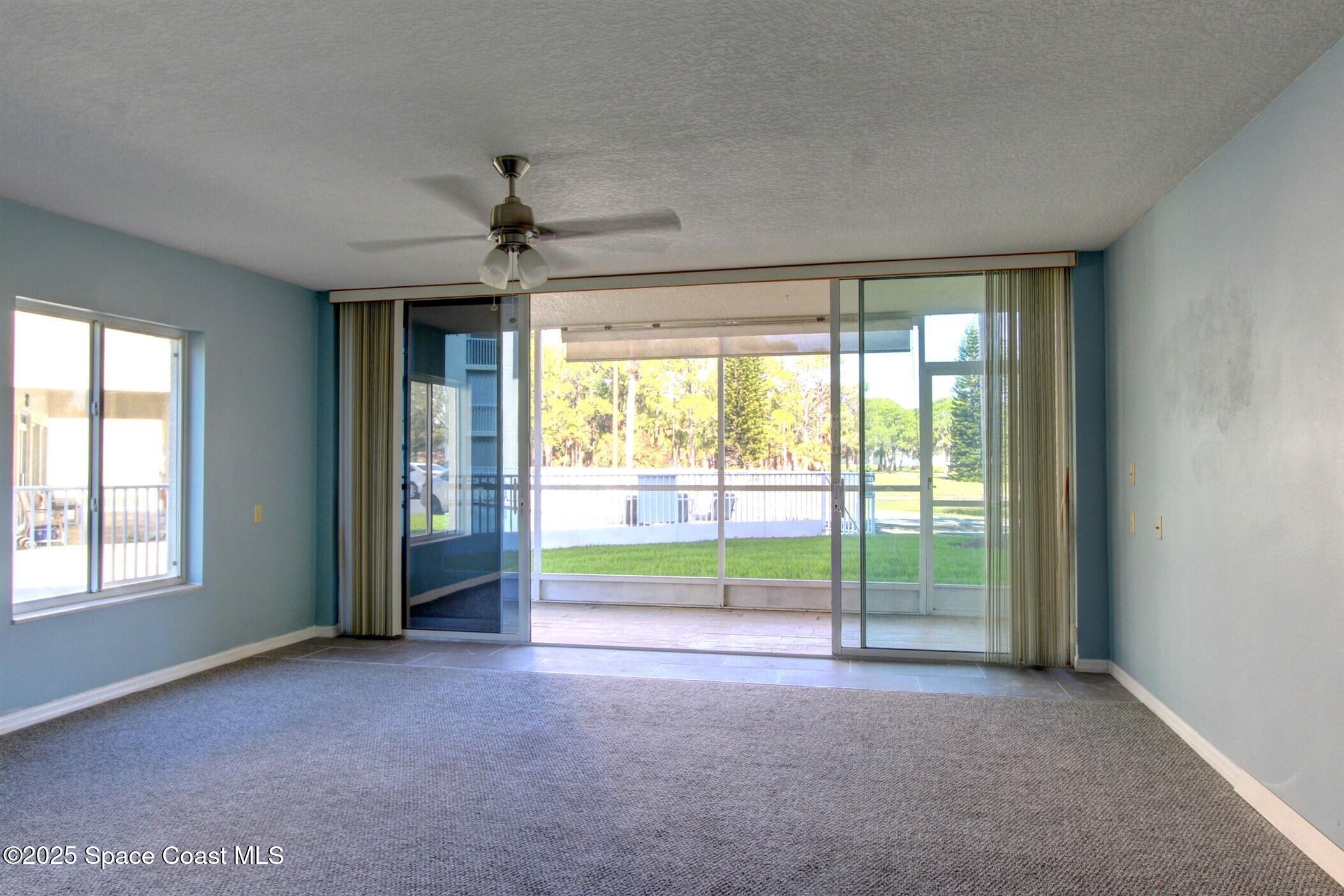 1420 Huntington Lane, Unit 2101 Rockledge, FL 32955 - Photo 14 of 38 a view of livingroom with a ceiling fan and window