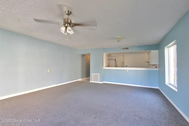 a bathroom with a granite countertop sink toilet and mirror