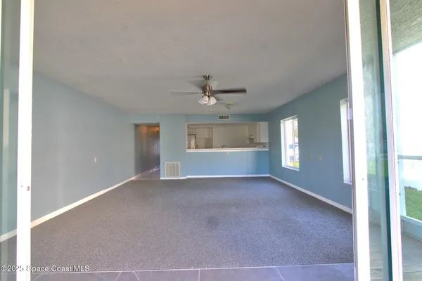 a view of washer and dryer with bathroom in the background