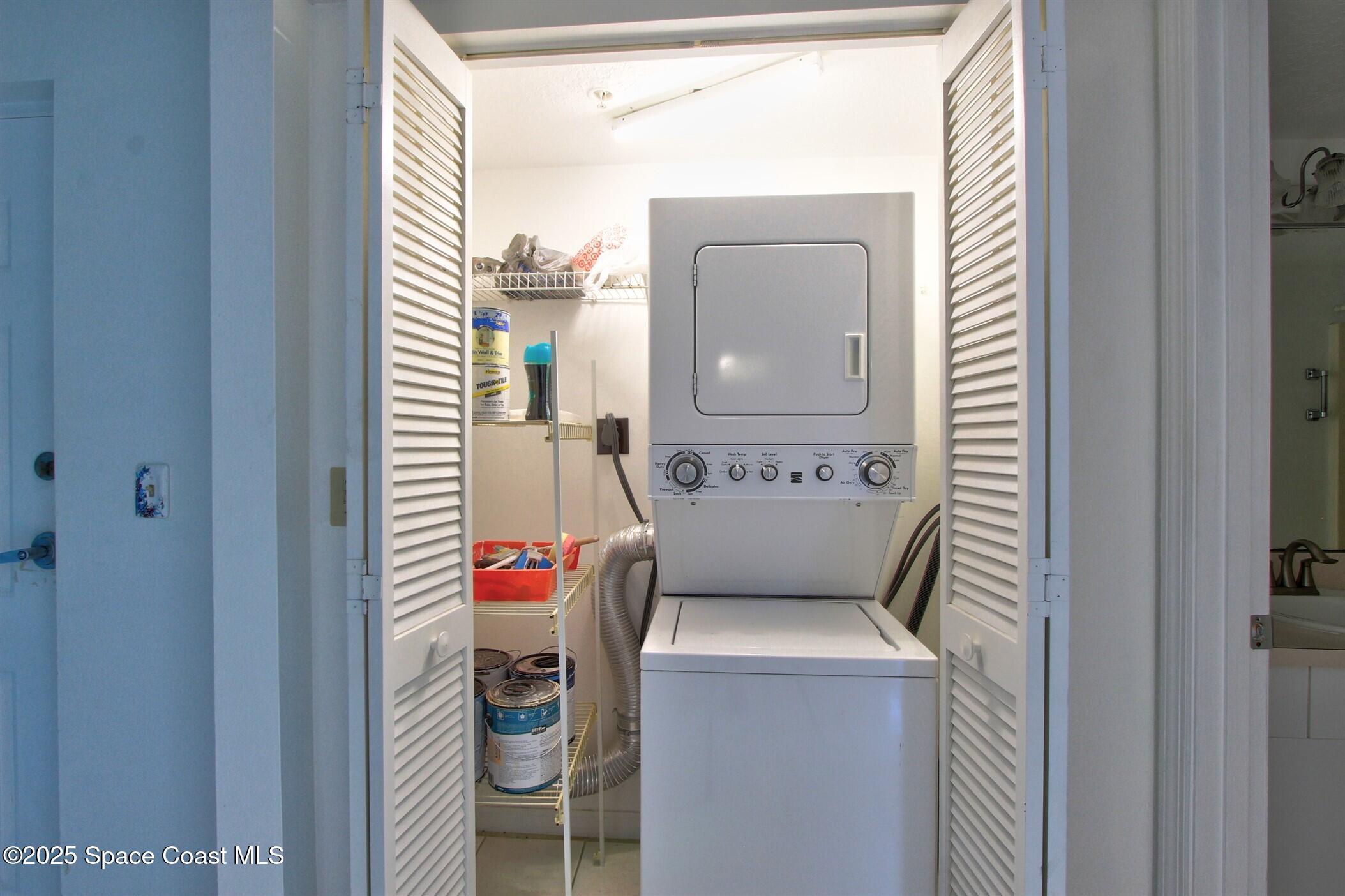 1420 Huntington Lane, Unit 2101 Rockledge, FL 32955 - Photo 21 of 38 a view of washer and dryer with bathroom in the background