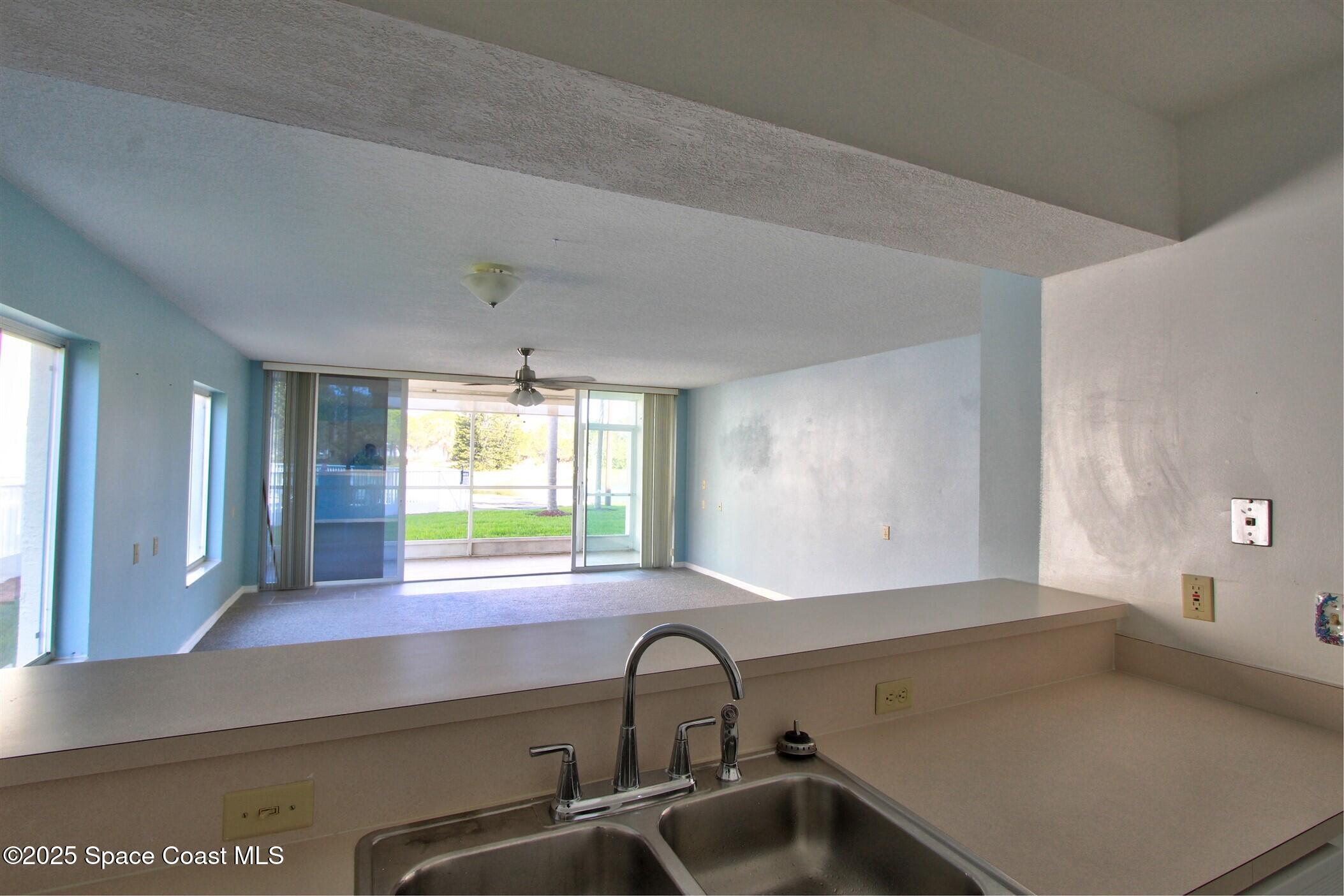 1420 Huntington Lane, Unit 2101 Rockledge, FL 32955 - Photo 23 of 38 a kitchen with a sink and windows