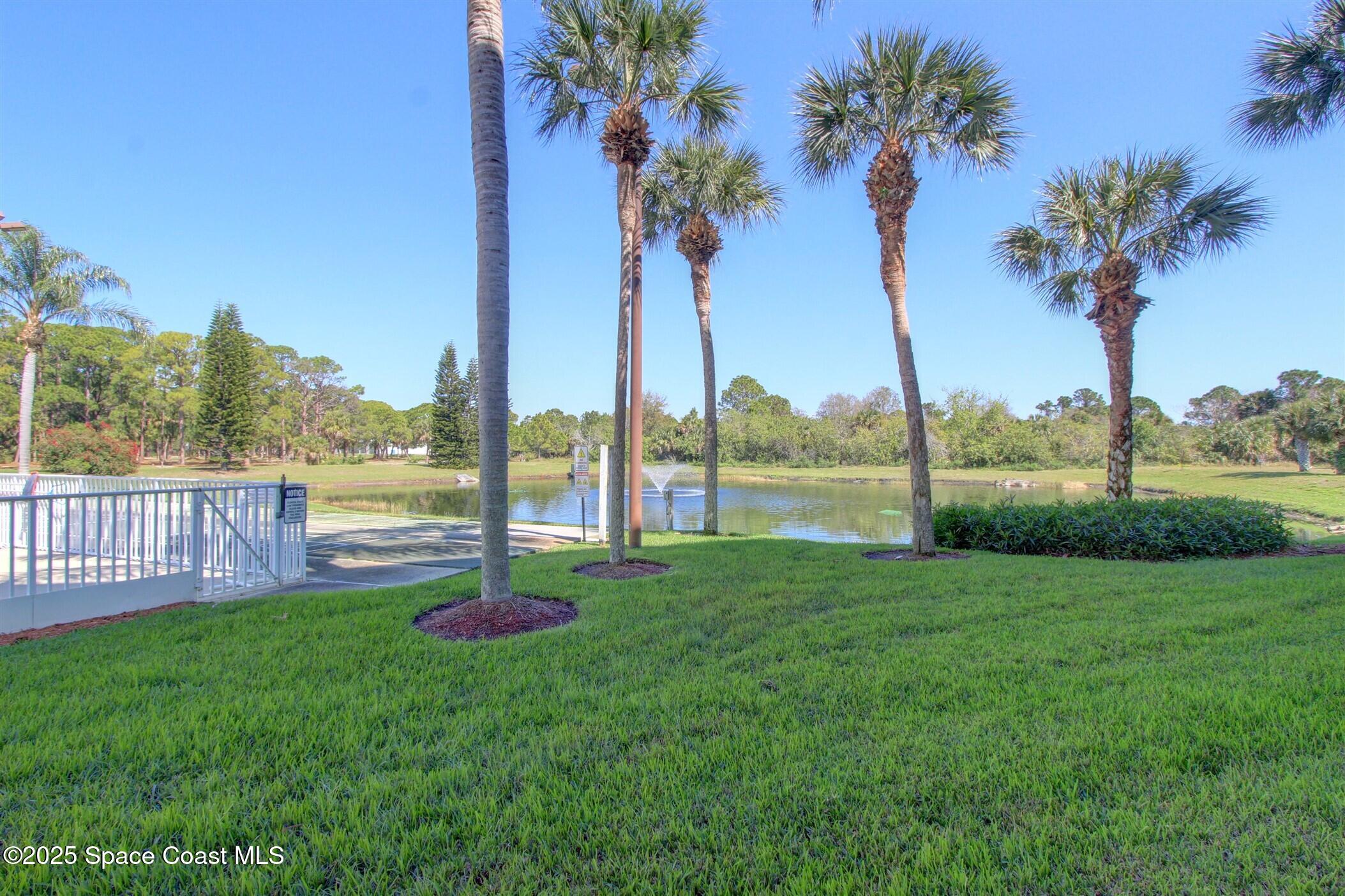 1420 Huntington Lane, Unit 2101 Rockledge, FL 32955 - Photo 4 of 38 a view of a garden and lake