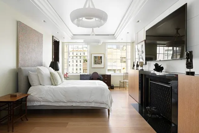 a view of a couches and dinning table under an umbrella