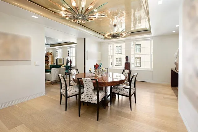 a living room with furniture a rug and a large window